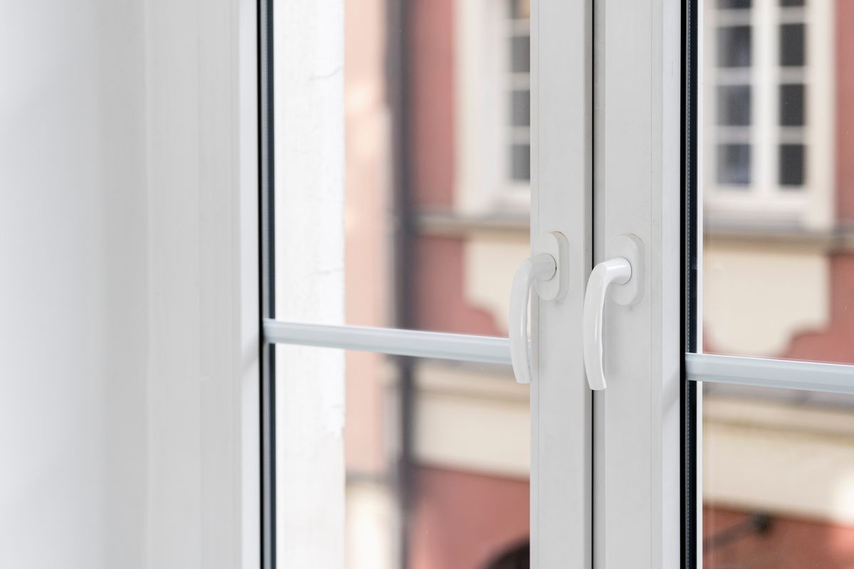 Closeup on pvc window with white frame, transparent glass and handles